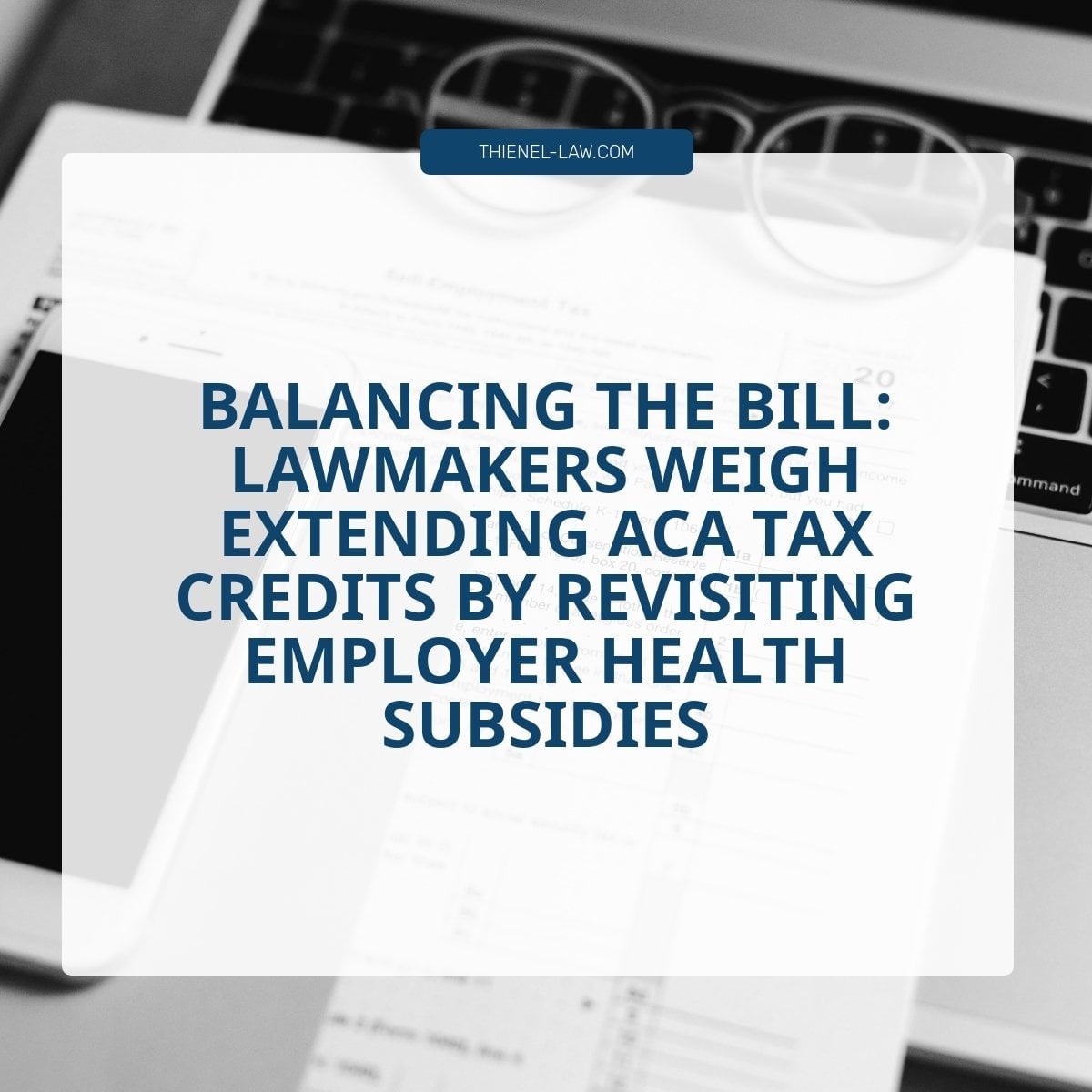 Laptop keyboard and eyeglasses on documents with text about ACA tax credits and employer health subsidies