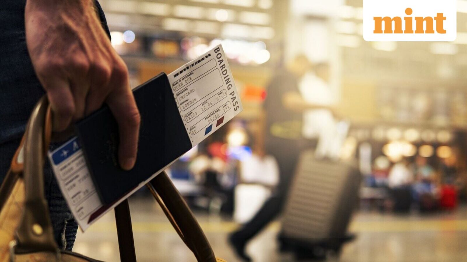 Person holding film production clapperboard in airport or transit terminal with blurred background