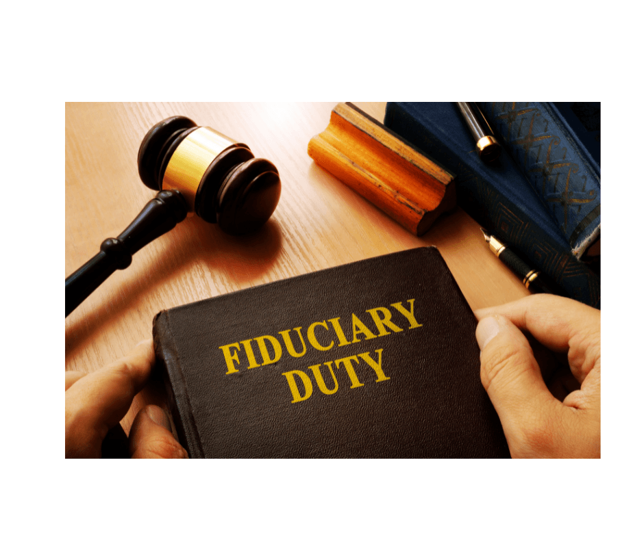 Hand holding a fiduciary duty book next to a gavel, law books, and wooden desk