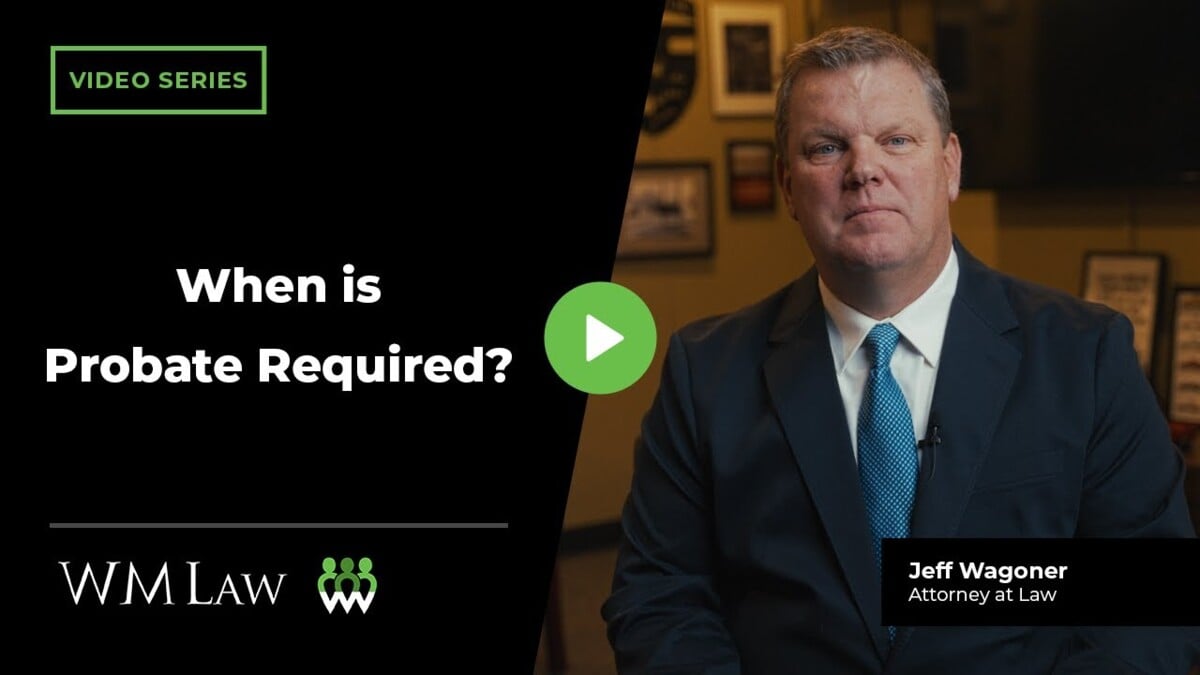 Attorney Jeff Wagoner in business suit speaks to camera in professional office setting with green play button overlay